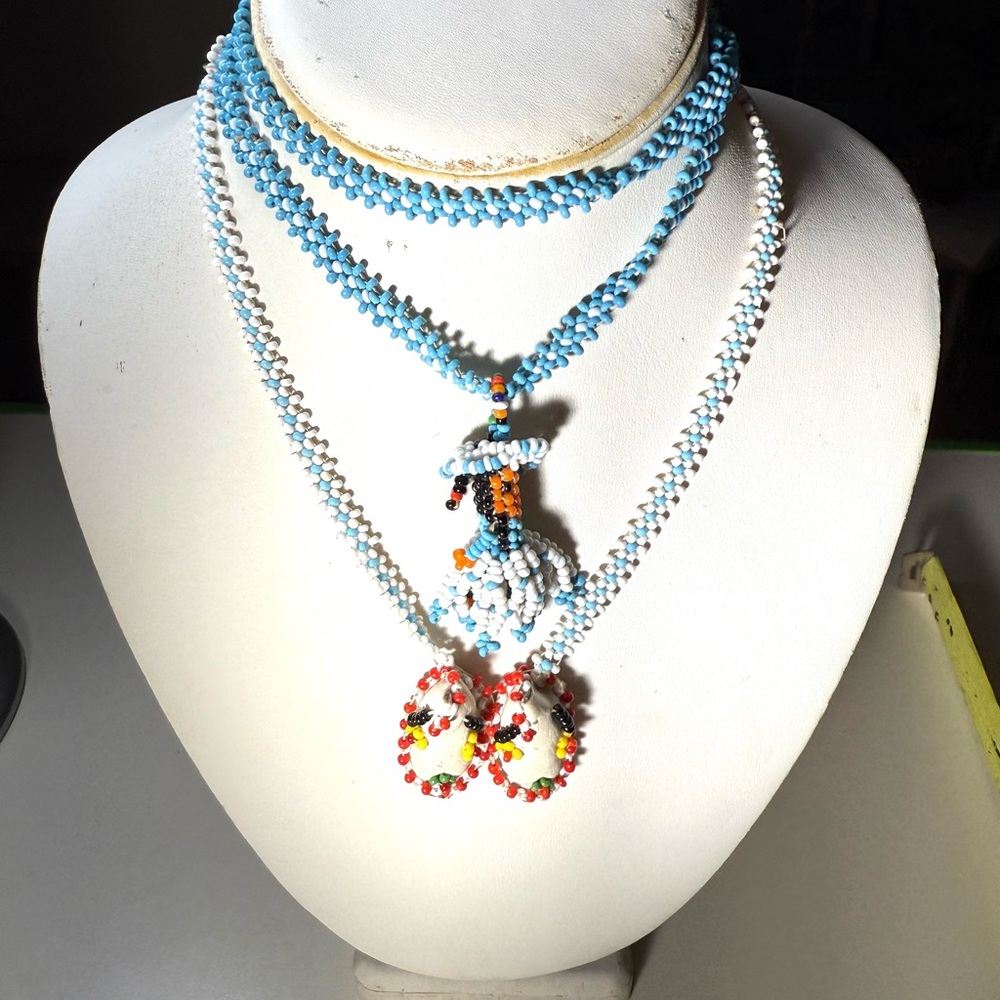 Vintage Native American seed bead necklaces,a pair of moccasins & a young girl.